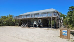 A two-story wooden building with a balcony, a sign for 'The Lost Flip Flop', and a wooden fence. - Easy Beach Access - Short 2 block walk to the beach! (St. George Island)