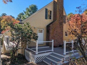 Stroll up to the charming two-story home with a cozy porch and brick chimney.
