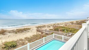 A pool with a view of the beach and ocean. - The Sale Fish: Modern Oceanfront Home with Private Pool and Elevator (Oak Island)