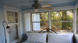 A bedroom with a bed, a window, and a ceiling fan. - Beautiful vintage cottage remodeled in Old Ocean Springs (Ocean Springs)