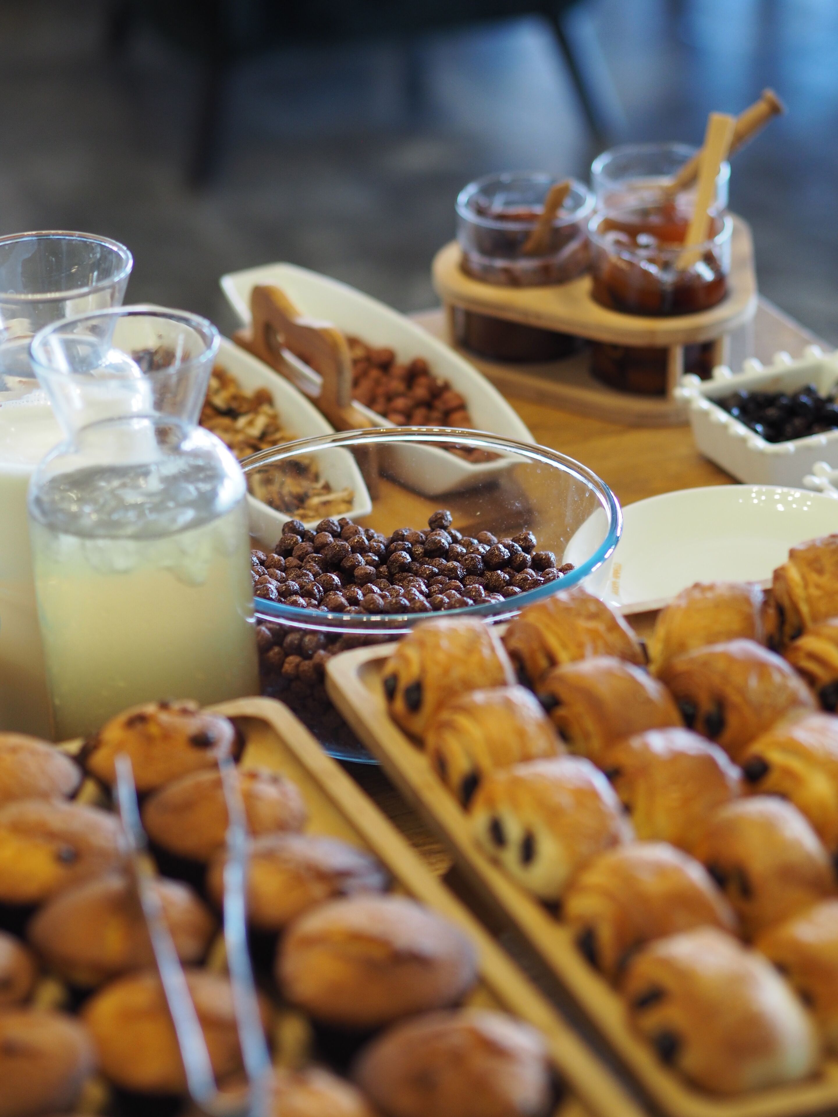 A buffet with various food items including pastries, fruits, and beverages.