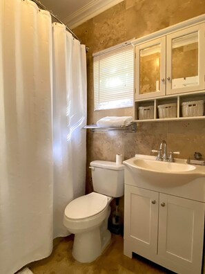 Shower, hair dryer, towels, toilet paper