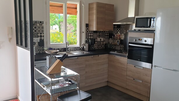 A modern kitchen with a microwave, oven, and sink.