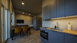 A modern kitchen with dark cabinets, a wooden countertop, and a built-in oven. - Modern  apartment located in central Reykjavik. - Studio 2 (Reykjavík)