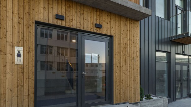 A building facade with a wooden panel design and a large '20' sign. - Modern  apartment located in central Reykjavik. - Studio 3 (Reykjavík)