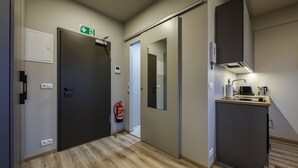 A modern kitchen with a built-in stove, a coffee machine, and a small countertop. - Modern  apartment located in central Reykjavik. - Studio 3 (Reykjavík)