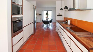 A modern kitchen with white cabinets, a stainless steel refrigerator, and a wooden countertop. - 2 bedroom beautiful apartment in Samsø (Samsø)