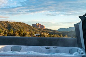 A hot tub with a view of a mountainous landscape and a building in the distance. - Sedona Epic Dream! 5BR Pool/Slide/Spa/Sauna! (Sedona)