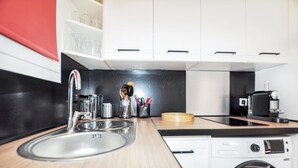 A compact kitchen with a sink, a coffee machine, and a washing machine. - Stunning apartment in Saint Cyprien Plage (Saint Cyprien Plage)