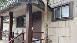 A wooden building with a porch, a door labeled "SPYGLASS," and a window.