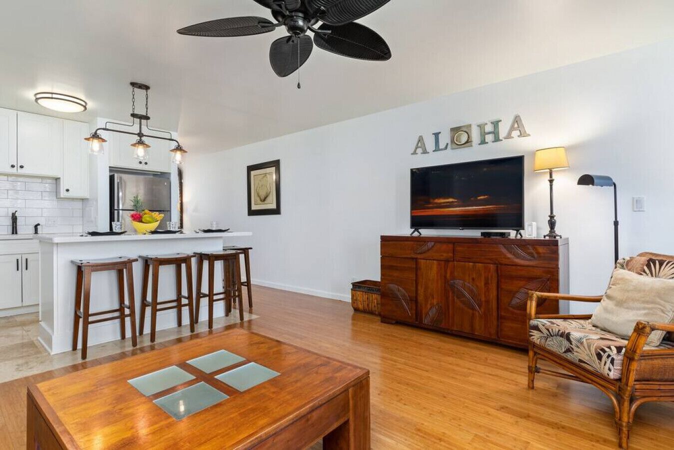 A modern living room with a wooden coffee table, a TV, and a sofa.