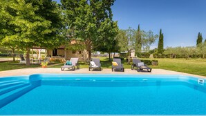 A swimming pool with lounge chairs and a stone building in the background. - Pet friendly home in Svetvincenat (Svetvincenat)
