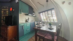 A kitchen with teal cabinets, a microwave, and a dining table set for two. - Beautiful home in Chaam with WiFi (Chaam)