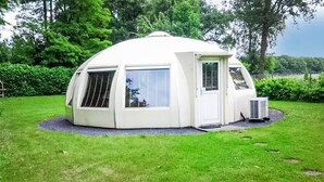 A dome-shaped, white, insulated structure with a door and windows, surrounded by grass and trees. - Beautiful home in Chaam with WiFi (Chaam)