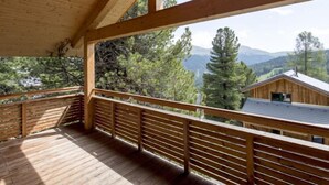 A wooden deck with a view of a mountain landscape. - #27 mit IR-Sauna und Sprudelbad Innen by Interhome (Turracher Höhe)