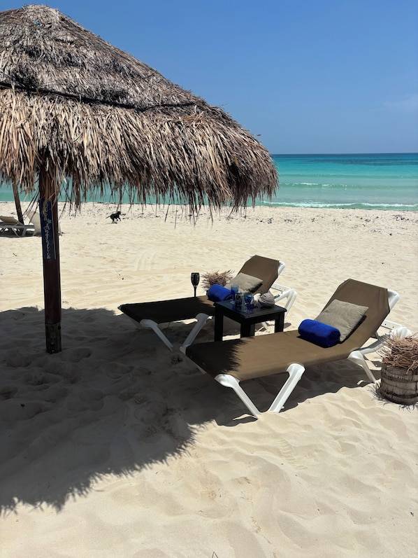 On the beach, sun-loungers, beach towels