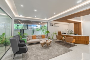 A modern reception area with a wooden desk, a sofa, and a coffee table.