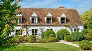 A traditional white building with a tiled roof and multiple windows. - Lovely home in Yèvre-la-Ville (Yèvre-la-Ville)
