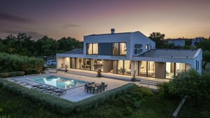 A modern two-story house with a swimming pool, outdoor seating, and a well-maintained garden. - Awesome home in Rakalj (Rakalj)