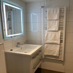 Shower, hair dryer, towels, toilet paper