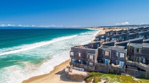 A coastal hotel with modern architecture, featuring multiple balconies and a beach view. - 3870 Sand Castle - Ocean Front, Pools, Hot Tubs (Monterey)