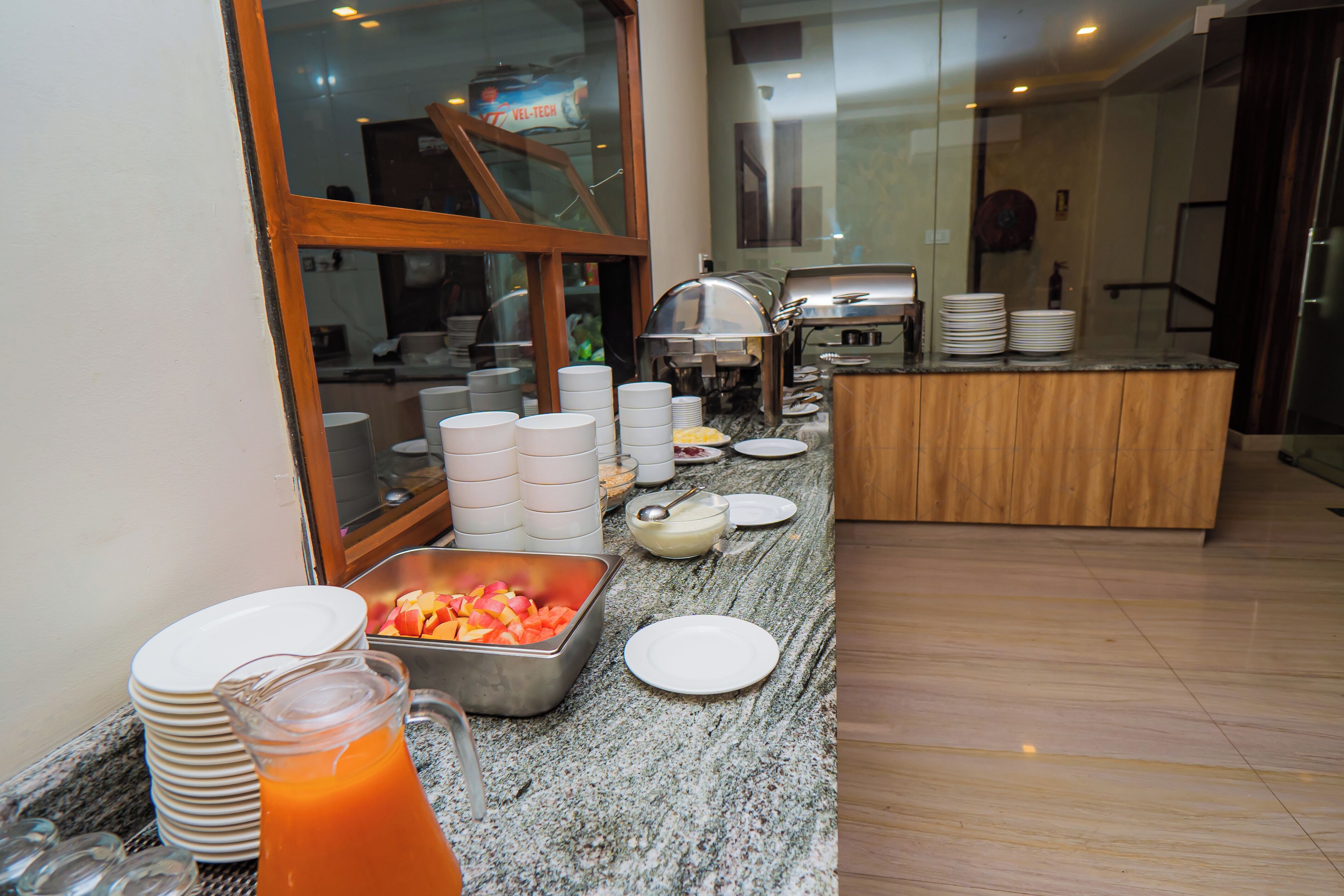 A buffet setup with various food items and utensils.