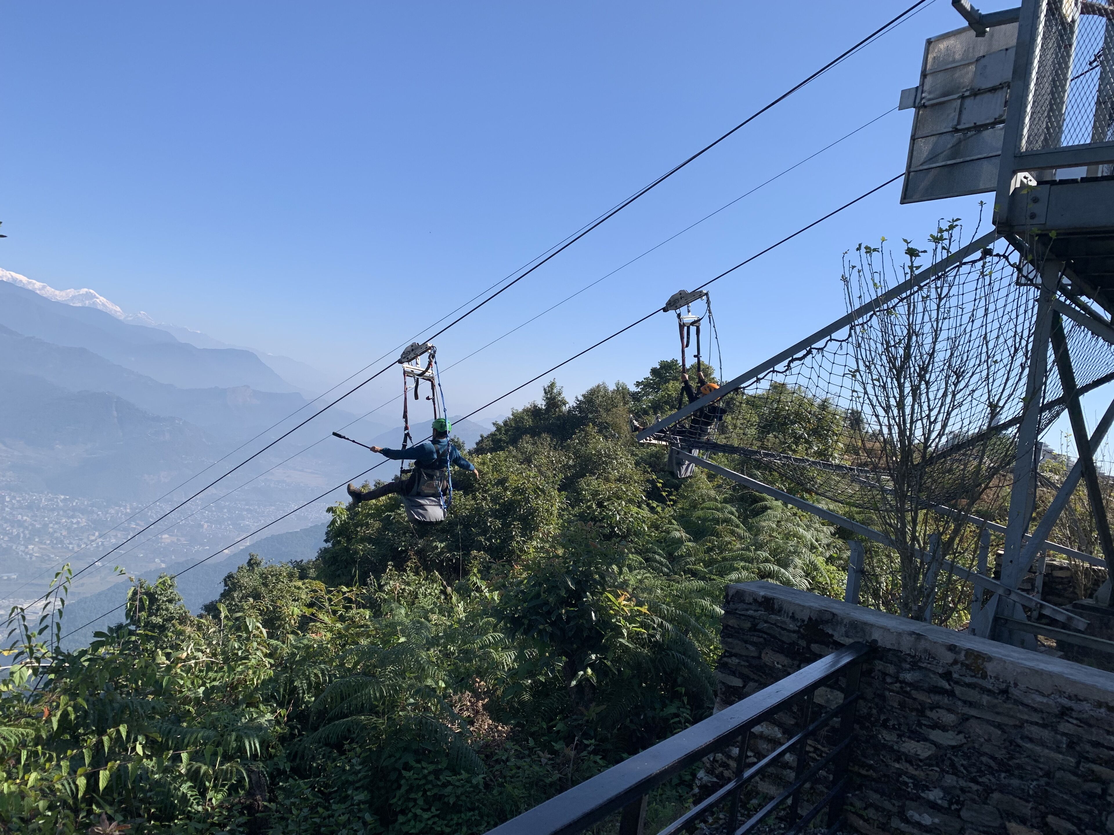 A cable car system with a mountainous backdrop.