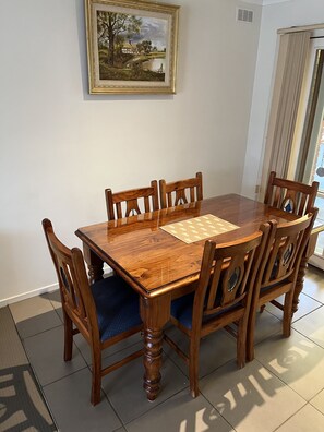 Enjoy meals in this dining area with a wooden table and six comfortable chairs.
