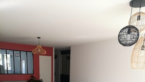 A modern living room with a sofa, chairs, and a dining table. - House 200m from the beach (Noirmoutier-en-l'Île)