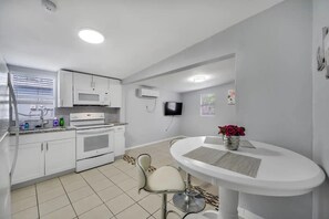 Fridge, stovetop, electric kettle, cookware/dishes/utensils