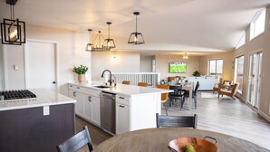 A modern kitchen with white cabinets, a central island, and pendant lighting. - Gorgeous Retreat with Mountain Views, Open Living, Game Room, Hot Tub (Glenwood Springs)