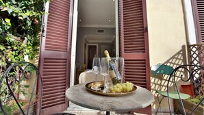 Ein Tisch mit einer Champagnerflasche, zwei Gläsern und einer Platte mit Trauben.