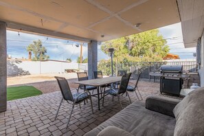 An outdoor patio with a table and chairs, a grill, and a sofa. - Spacious home. Perfect for large groups family friendly 5 bed/ 3 bath 
 (Phoenix)