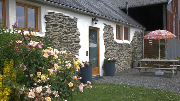 A stone house with a wooden door, a number '2' sign, and a flower bed in front. - Idyllic Country Location for couples, central, peaceful, 5 mins from shops, WIFI (LOPEREC)