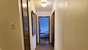 A hallway with a tiled floor, wooden steps, and doors on both sides. - Delightful Spacious 3-bedroom Home in Silicon Valley (Santa Clara)