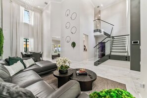 A modern living room with a sofa, coffee table, and decorative wall art.