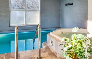 A swimming pool with a hot tub, a window, and a potted plant. - Nice home in Nørre Nebel with sauna (Nørre Nebel)