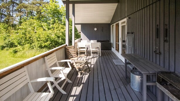 A wooden deck with white chairs and a grill. - Nice home in Samsø with kitchen (Samsø)
