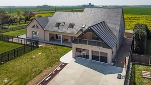 A modern two-story house with a sloped roof, large windows, and a spacious patio area. - Amazing home in La Chapelle-Vendômoise (La Chapelle-Vendômoise)