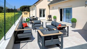 An outdoor patio with a sofa set, a table, and a grill. - Amazing home in La Chapelle-Vendômoise (La Chapelle-Vendômoise)