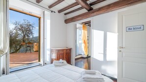 Une chambre à coucher avec un grand lit, une armoire en bois et une porte sur laquelle est affiché un panneau avec l’inscription « Soyez aimable ».