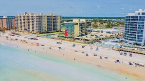 A beachfront hotel with multiple high-rise buildings, a pool area, and beach access. - Friends & Family Beach Escape - Double Oceanview Studio Sleeps up to 10 (Daytona Beach)