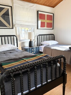 Bedroom 2 with two twin beds, dress and nightstand.