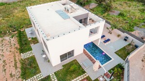 A modern two-story house with a rooftop terrace, a swimming pool, and a patio area with outdoor furniture. - Pet friendly home in Skrip (Skrip)