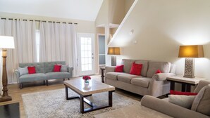 A living room with two sofas, a coffee table, and a lamp. - New modern kitchen in great location to RDU and RTP (Morrisville)