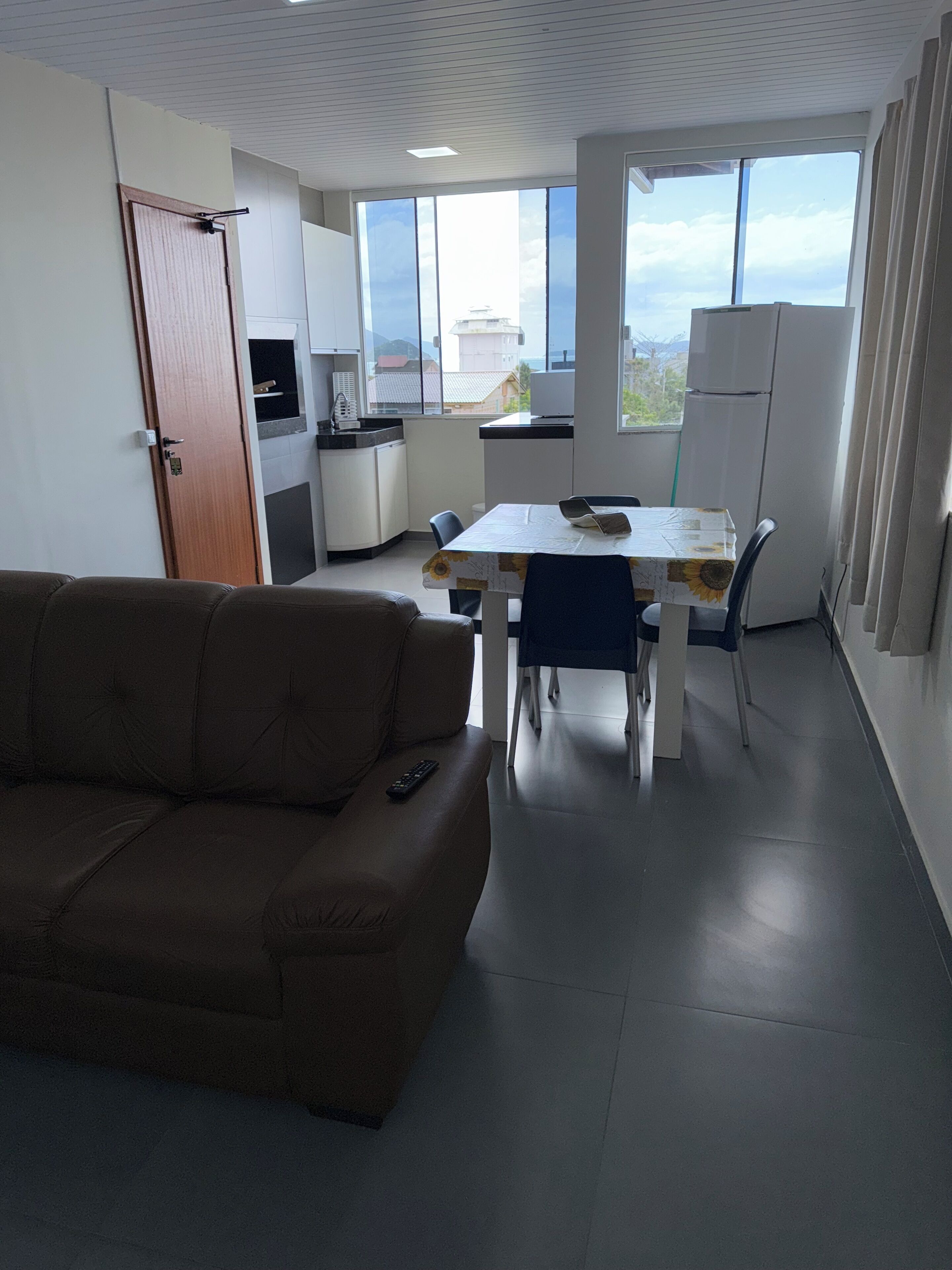 A modern living room with a sofa and a dining table.