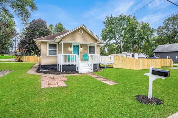 A single-story house with a front porch, a mailbox, and a well-maintained lawn.