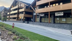 A multi-story building with a modern design, featuring balconies and large windows. - Spring Creek Luxury One Bedroom Sleeps 4 (Canmore)