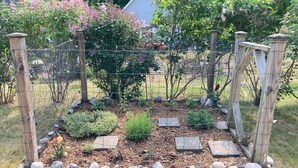 A garden bed with a wooden frame, rocks, and various plants. - Latitude Adjustment II - SIMPLY GORGEOUS WITH GREAT LOCATION CLOSE TO DOWNTOWN! (Frankfort)