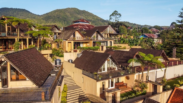 A traditional village with multiple two-story buildings, each featuring a balcony and a tiled roof. - Bedugul Lake View Villa (Buleleng)